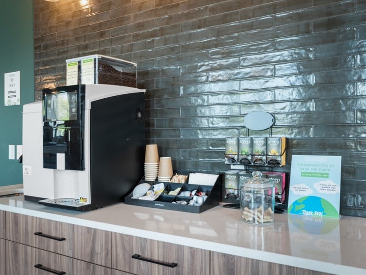 a coffee machine on a counter in front of a brick wall